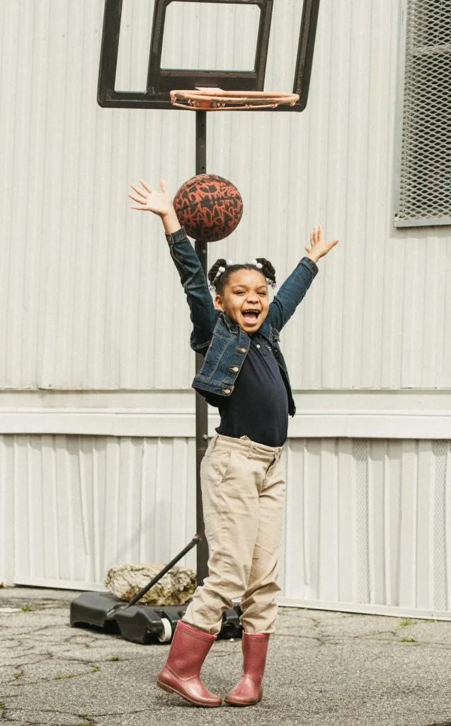 Photo: Smiling girl playing basketball